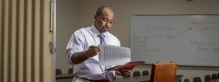 Photo of man reading papers 