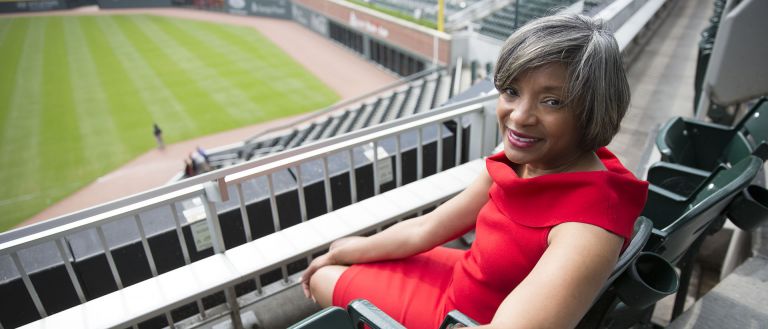 Woman sitting at baseball stadium