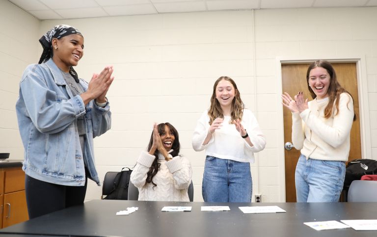  <p>Aspen Thompson (left) and JaQuira Wallace celebrate with fellow first-year cohort members Blazie Gilder and Malia Epps at an internship reveal party for students in the second-year cohort.</p>