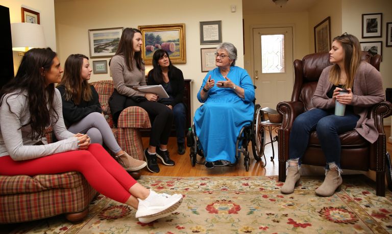 Woman surrounded by several listeners