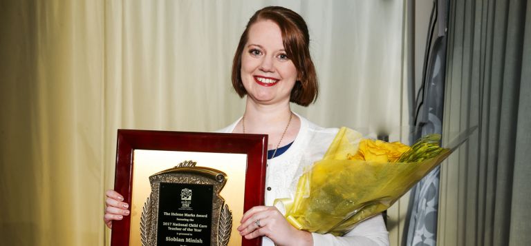 Woman holding award 