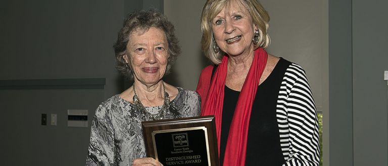 Woman holding award 